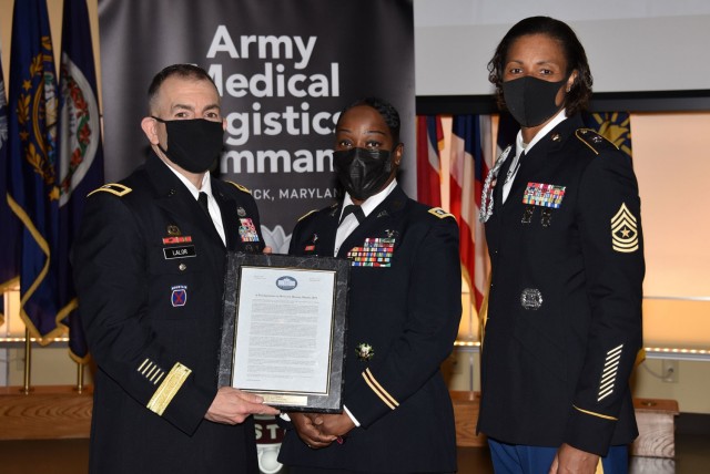 Brig. Gen. Michael Lalor, left, commander of U.S. Army Medical Logistics Command, and AMLC Sgt. Maj. Danyell Walters recognize Lt. Col. Tyra Fruge for serving as the guest speaker at AMLC’s Women’s History Month commemoration event March 26 at Fort Detrick, Maryland.