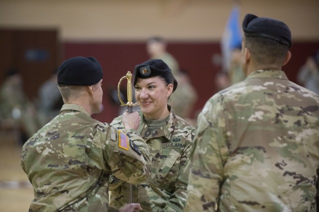 Then-Command Sgt. Maj. Julie A. Guerra, center, symbolically assumes responsibility for the noncommissioned corps with the passing of the noncommissioned officers' sword by then-Col. Kris A. Arnold, the 501st Military Intelligence Brigade commander, during a change of responsibility ceremony at Camp Humphreys, South Korea, Feb. 11, 2016. Guerra is now the G-2's senior enlisted advisor.