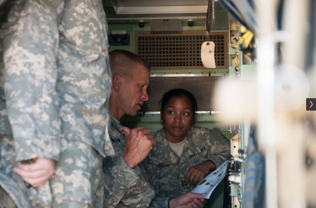 U.S. Army Maj. Marni Prenell, an inspector general with the Assistance Division at the U.S. Army Inspector General Agency, listens to then 1st Infantry Division Command Sgt. Maj. Michael Grinston during training event at Fort Riley, Kansas, in 2014. Grinston is now the Sgt. Maj. of the Army. (U.S. Army photo courtesy of Maj. Marni Prenell) 
