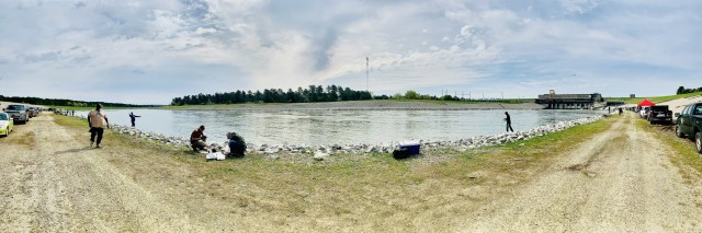 People fishing along river