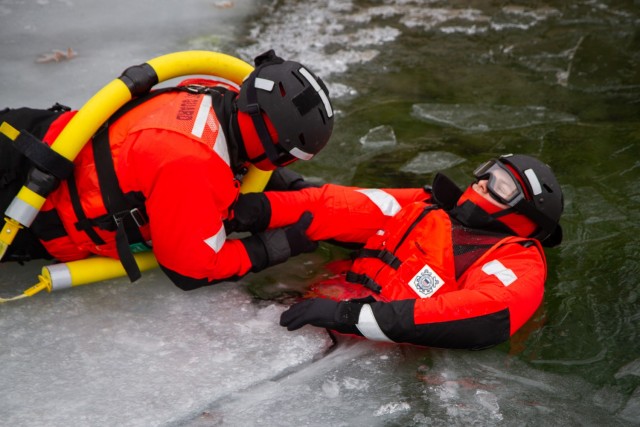 Members of the Coast Guard conduct ice rescue training with a simulated survivor in the water at U.S. Coast Guard Station Alexandria Bay, New York, March 16, 2021. The Coast Guard Station provides law enforcement, search and rescue, as well as...