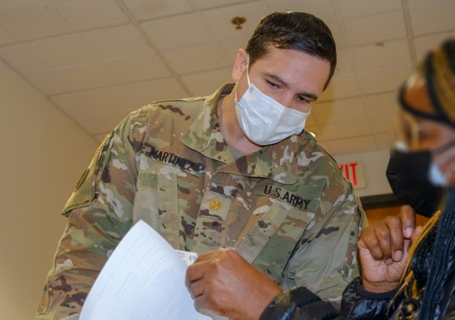 U.S. Army Maj. Andy Martinez, a medical doctor, assigned to the 531st Hospital Center, discusses medical information about the COVID-19 vaccine with a local citizen at the state-run, federally-supported First Baptist Church of Lincoln Gardens Community Vaccination Center in Somerset, New Jersey, Feb. 27, 2021. U.S. Northern Command, through U.S. Army North, remains committed to providing continued, flexible Department of Defense support to the Federal Emergency Management Agency as part of the whole-of-government response to COVID-19.  (U.S. Army photo by Sgt. Robert O’Steen, 5th Mobile Public Affairs Detachment)