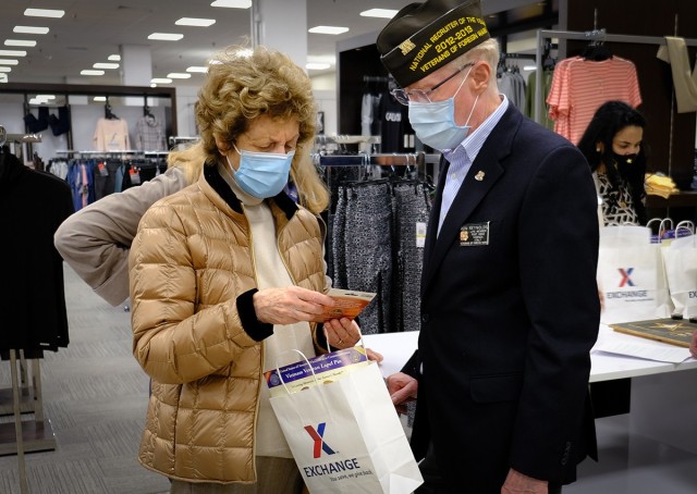 Master Sgt. (Ret.) Ron Reynolds, a VFW Post 8862 service officer, gives Vietnam Veteran widow Carmen Quinn a gift bag courtesy of The Exchange. It included discounts and commissary gift cards during Vietnam War Recognition Day, March 29, 2021 in...