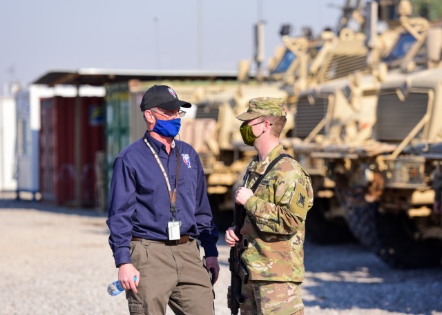 Brian L. Debutts, logistics assistance representative, 401st Army Field Support Brigade, advises Sgt. Tommy D. Riddick, U.S. Army Signal Support Systems specialist, on matters involving Single Channel Ground and Airborne Radio System/ Advanced...