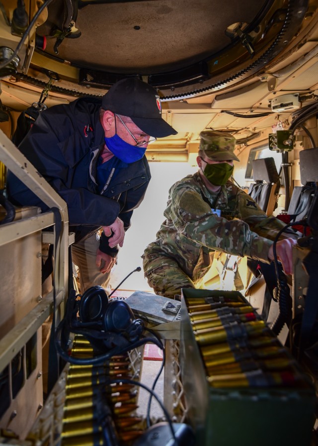 Brian L. Debutts, logistics assistance representative, 401st Army Field Support Brigade, advises Sgt. Tommy D. Riddick, U.S. Army Signal Support Systems specialist, on matters involving Single Channel Ground and Airborne Radio System/ Advanced...