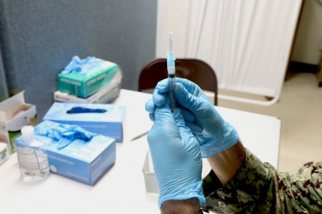 U.S. Navy Hospital Corpsman 2nd Class Dyllon Canady, a Las Vegas native and a surgical technician assigned to the Naval Health Clinic Oak Harbor, prepares the COVID-19 vaccine at the state-run, federally-supported St. Matthew African Methodist...