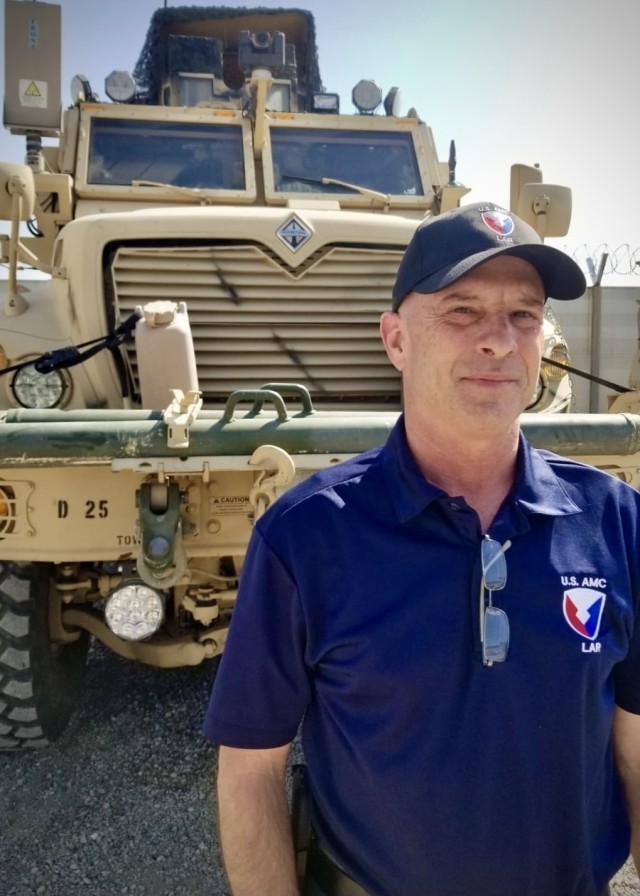 Brian L. Debutts, logistics assistance representative, 401st Army Field Support Brigade, stands by a Mine Resistant Ambush Protected (MRAP) Maxxpro at Erbil Ari Base, Iraq, Feb. 23, 2021. LARs like Debutts specialize in providing technical...
