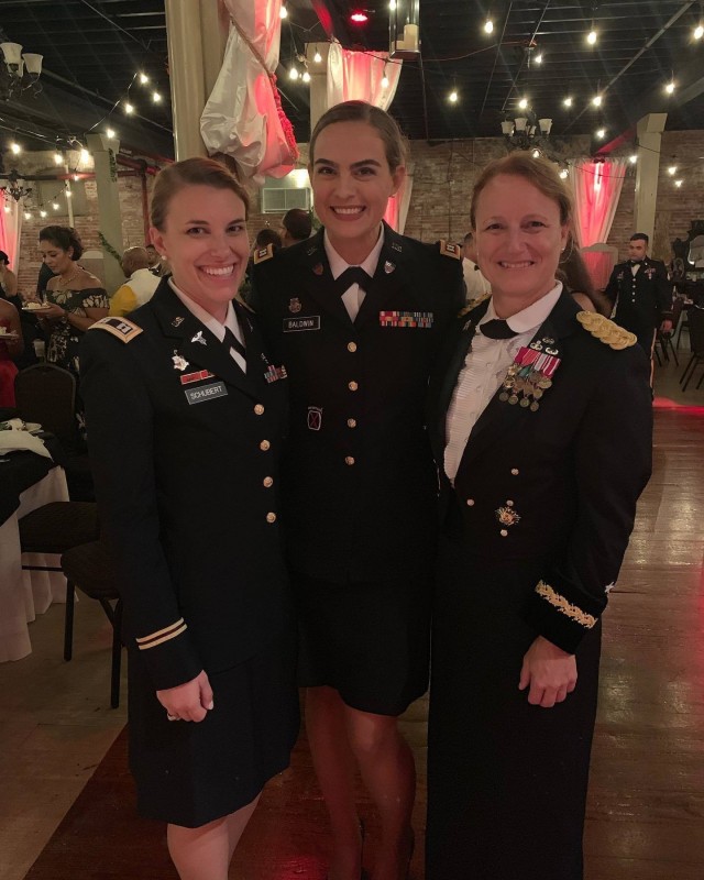 Capt. Celina Baldwin, center, G1 essential personnel services officer in charge, 1st Theater Sustainment Command, stands with fellow West Point graduates Brig. Gen. Michelle Schmidt, right, and Capt. Sara Schubert, left, at the 710th Brigade Support Battalion, 3rd Infantry Brigade Combat Team, 10th Mountain Division Ball in 2019. Baldwin, a Tampa, Florida, native, was nominated for the General Douglas MacArthur Leadership Award by the 1st TSC and U.S. Army Central.