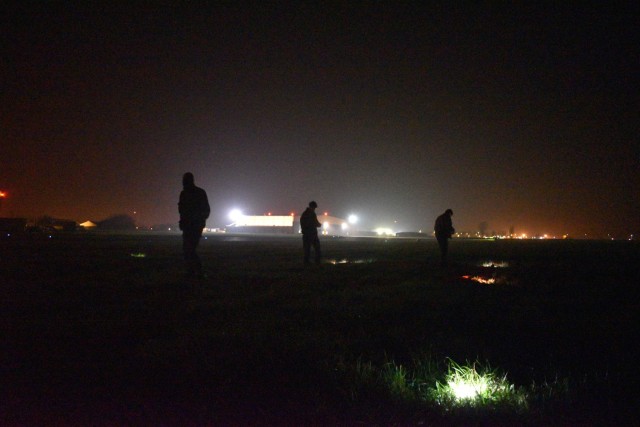 CHIÈVRES, Belgium – Members of the Belgian Paratroopers Training Center set lights out on the airfield grass for members of the Belgian Special Forces Group to land by during the night. For the first time, U.S. Army Garrison Benelux and 424th Air Base Squadron – an Air Force element at the garrison – hosted the Belgian Defense Forces’ Paratroopers Training Center as they held training and qualification jumps for their paracommandos March 1, 2021. (U.S. Army photo by Bryan Gatchell, USAG Benelux Public Affairs)