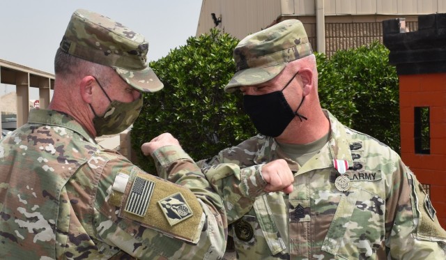Following COVID19 protocol Major Ed Zook and SGM Nathan Marshall engage in a final elbow bump as Marshall readies to redeploy from the Transatlantic Afghanistan District. (Photo by Rick Benoit)