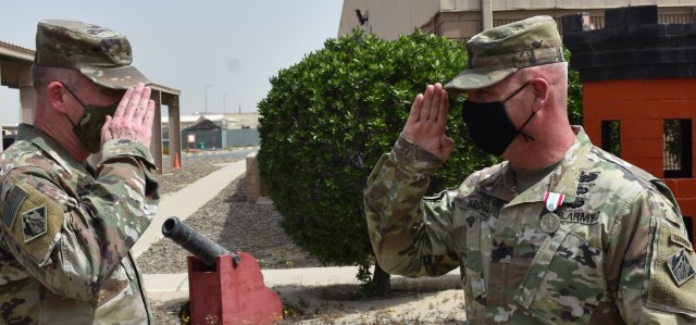 A final salute from Operations Officer in Charge Major Ed Zook to Senior Enlisted Leader SGM Nathan Marshall at Camp Arifjan, Kuwait. (Photo by Rick Benoit)