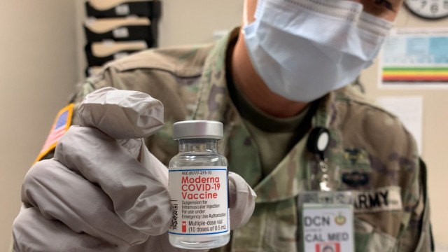 Maj. Jodi Brown, Chief of Public Health at the California Medical Detachment, Presidio of Monterey, prepares syringes for the paramedics administering the Moderna vaccine at Fort Hunter Liggett, March 23, 2021.
