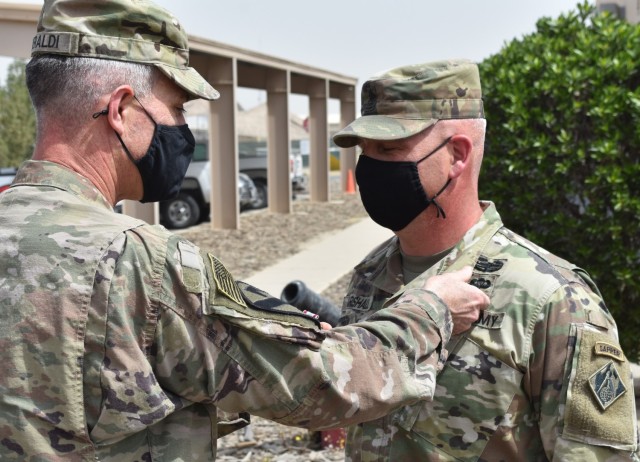 Sergeant Major Nathan Marshall is presented with the Defense Meritorious Service Medal as he prepares to redeploy from the Transatlantic Afghanistan District. (Photo by Rick Benoit)