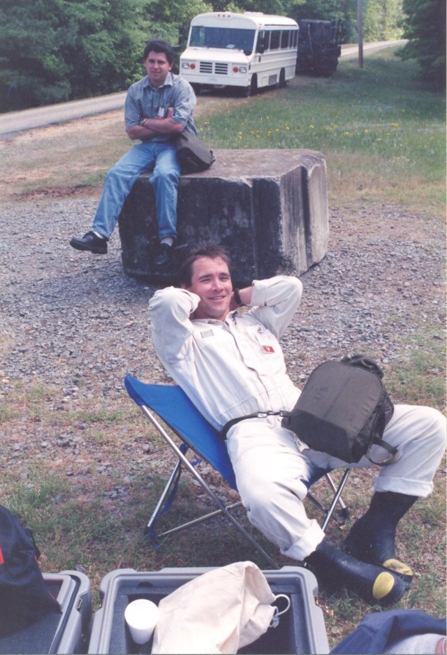 Mr. Steven T. Bird, front, takes a break during ground-breaking work in the1997 XP27 assessment mission at Pine Bluff Arsenal, Arkansas.
