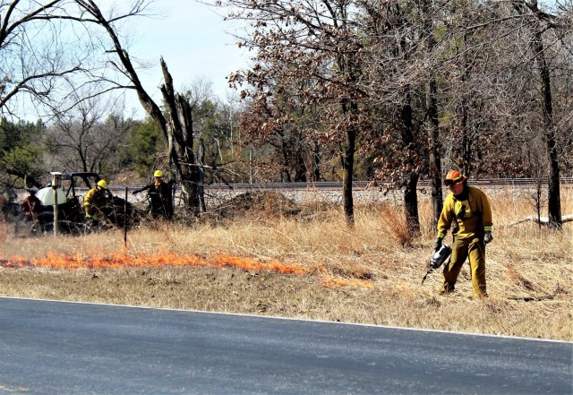 Forestry Technician Tim Parry lights a prescribed burn March 18, 2021, along the railroad tracks on South Post at Fort McCoy, Wis. The post prescribed burn team includes personnel with the Fort McCoy Directorate of Emergency Services Fire Department; Directorate of Public Works (DPW) Environmental Division Natural Resources Branch; Directorate of Plans, Training, Mobilization and Security; and the Colorado State University Center for Environmental Management of Military Lands, under contract with the post. Prescribed burns also improve wildlife habitat, control invasive plant species, restore and maintain native plant communities, and reduce wildfire potential. Prescribed burns benefit the environment many ways and are one of the tools we can use on a large scale to improve our wild habitat, said Fort McCoy Forester Charles Mentzel with the Directorate of Public Works Natural Resources Branch. Mentzel said prescribed burns help set back invasive species, and they burn up their seed banks. Burns also give native species an opportunity to compete against some of the non-native species, as many native species depend on fire to help stimulate them and set back non-native species. (Photo by Scott Sturkol, Fort McCoy Public Affairs Office)