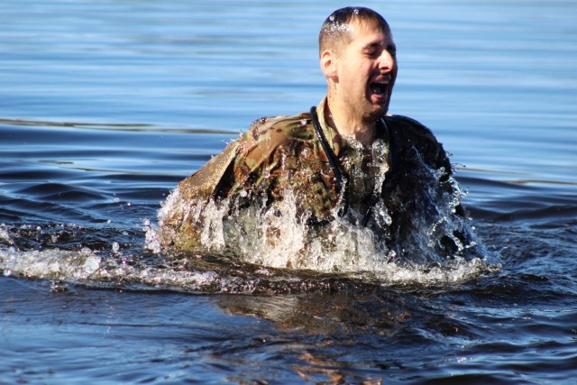 A student in Fort McCoy Cold-Weather Operations Course (CWOC) class 21-05 participates in cold-water immersion training March 19, 2021, at Big Sandy Lake on South Post at Fort McCoy, Wis. CWOC students are trained on a variety of cold-weather...