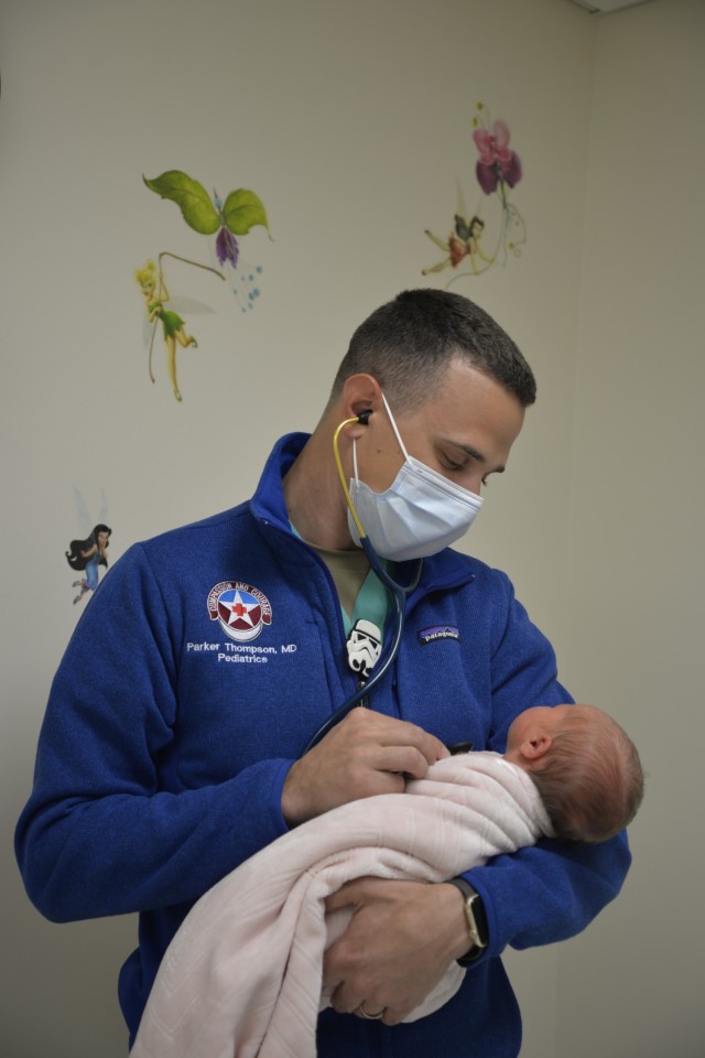 Capt. Parker Thompson, pediatrician and officer in charge of the COVID-19 vaccination clinic for General Leonard Wood Army Community Hospital, monitors an infant’s heartbeat during a wellness check March 26.