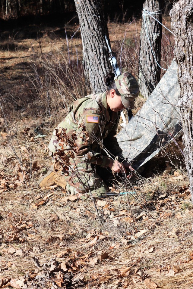 A student in Fort McCoy Cold-Weather Operations Course (CWOC) class 21-05 participates in shelter-building training March 11, 2021, at Fort McCoy, Wis. CWOC students are trained on a variety of cold-weather subjects, including snowshoe training...