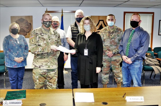 (From left) Fort McCoy Resource Management Officer Maureen Richardson, Garrison Commander Col. Michael Poss, Deputy to the Garrison Commander Brad Stewart, Vernon County Highway Commissioner Phil Hewitt, Vernon County Administrator Cari Reddington, Fort McCoy Staff Judge Advocate Lt. Col. Savas Kyriakidis, and Directorate of Public Works Operations and Maintenance Division Chief Nathan Sobojinski were all on hand for the signing of an intergovernmental service agreement (IGSA) between the post and Vernon County on March 15, 2021, at Fort McCoy, Wis. The agreement involves line striping on roadways at Fort McCoy and is estimated to save the installation more than $166,000 over the next 10 years. It is the second IGSA the post has made in the last two years. (U.S. Army Photo by Scott T. Sturkol, Public Affairs Office, Fort McCoy, Wis.)