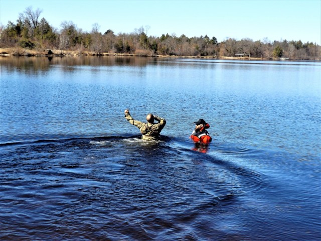 A student in Fort McCoy Cold-Weather Operations Course (CWOC) class 21-05 participates in cold-water immersion training March 19, 2021, at Big Sandy Lake on South Post at Fort McCoy, Wis. CWOC students are trained on a variety of cold-weather...