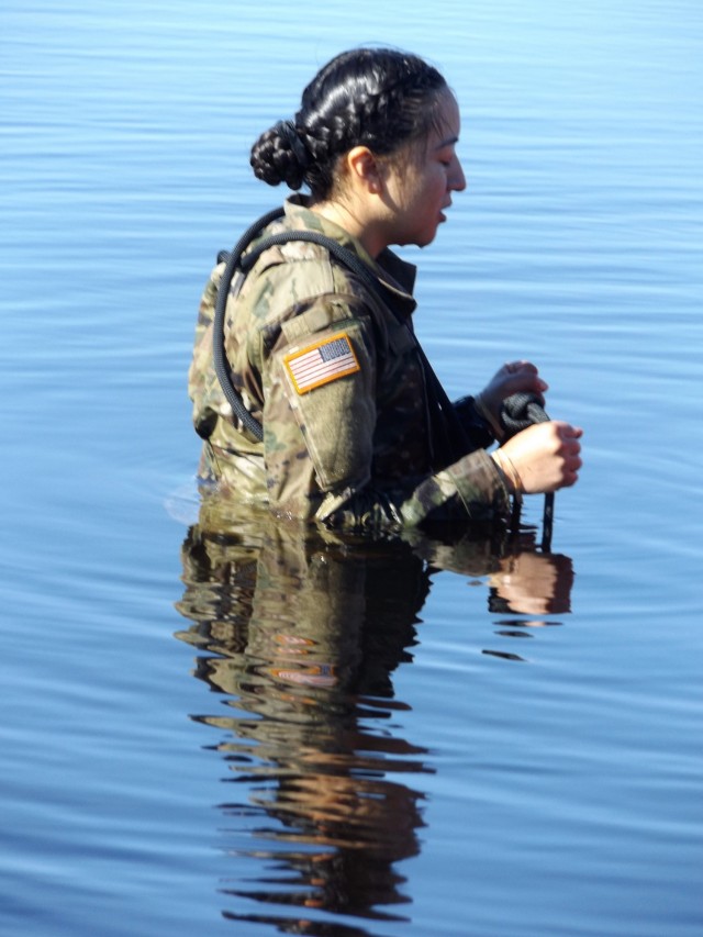 A student in Fort McCoy Cold-Weather Operations Course (CWOC) class 21-05 participates in cold-water immersion training March 19, 2021, at Big Sandy Lake on South Post at Fort McCoy, Wis. CWOC students are trained on a variety of cold-weather...