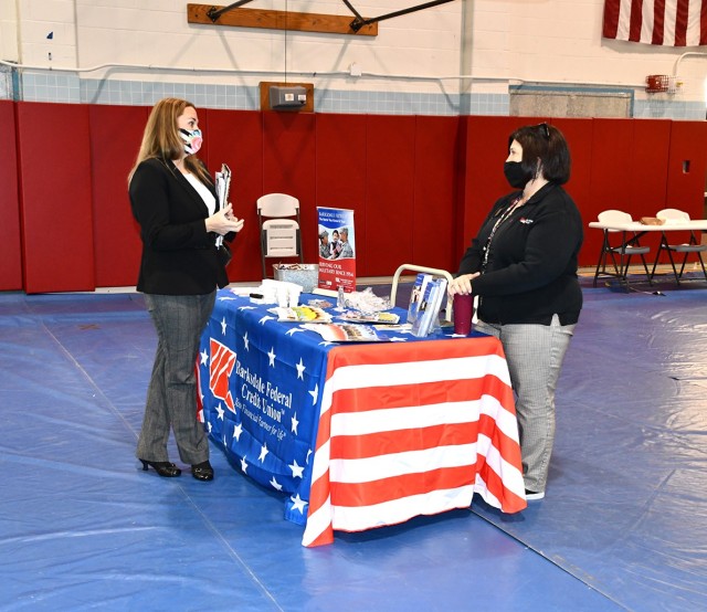 Michaelia McClure (left), military spouse, talks to Lori Clouse, Barksdale Credit Union, Leesville branch manager, at the Military Spouse Employment Fair March 24.
