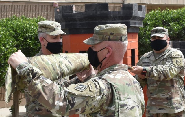 On March 18, 2021 at Camp Arifjan, Kuwait the command colors of the Transatlantic Afghanistan District are uncased by the Commanding Officer and Command Sergeant Major, Col. Mark Geraldi and SGM Nathan Marshall respectively. (Photo by Rick Benoit)