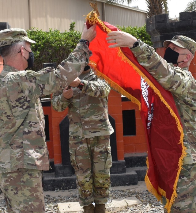 On March 18, 2021 at Camp Arifjan, Kuwait the command colors of the Transatlantic Afghanistan District are uncased by the Commanding Officer and Command Sergeant Major, Col. Mark Geraldi and SGM Nathan Marshall respectively. (Photo by Rick Benoit)