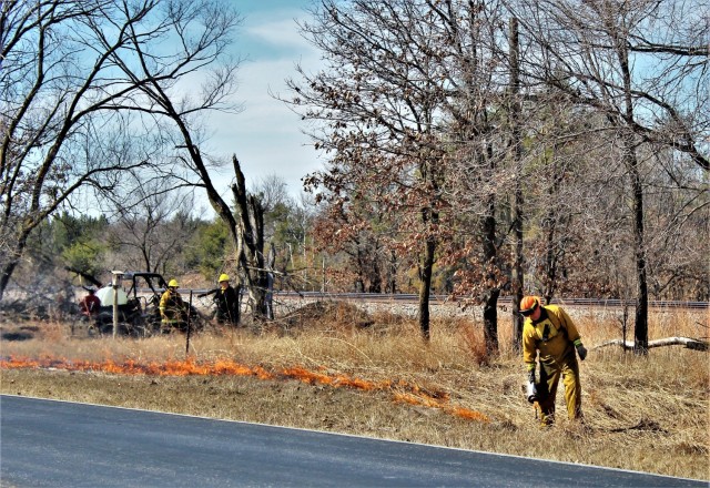 Forestry Technician Tim Parry lights a prescribed burn March 18, 2021, along the railroad tracks on South Post at Fort McCoy, Wis. The post prescribed burn team includes personnel with the Fort McCoy Directorate of Emergency Services Fire Department; Directorate of Public Works (DPW) Environmental Division Natural Resources Branch; Directorate of Plans, Training, Mobilization and Security; and the Colorado State University Center for Environmental Management of Military Lands, under contract with the post. Prescribed burns also improve wildlife habitat, control invasive plant species, restore and maintain native plant communities, and reduce wildfire potential. Prescribed burns benefit the environment many ways and are one of the tools we can use on a large scale to improve our wild habitat, said Fort McCoy Forester Charles Mentzel with the Directorate of Public Works Natural Resources Branch. Mentzel said prescribed burns help set back invasive species, and they burn up their seed banks. Burns also give native species an opportunity to compete against some of the non-native species, as many native species depend on fire to help stimulate them and set back non-native species. (Photo by Scott Sturkol, Fort McCoy Public Affairs Office)