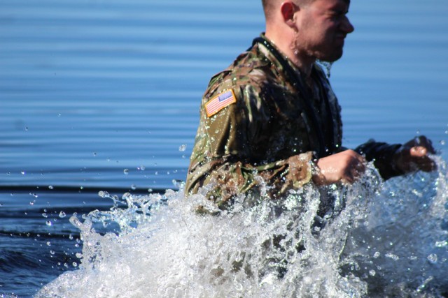 A student in Fort McCoy Cold-Weather Operations Course (CWOC) class 21-05 participates in cold-water immersion training March 19, 2021, at Big Sandy Lake on South Post at Fort McCoy, Wis. CWOC students are trained on a variety of cold-weather...