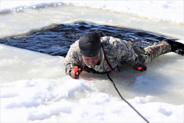 Airman 1st Class Alexis Edwards with the 164th Security Forces Squadron at Memphis Air National Guard Base, Tenn., participates in cold-water immersion training Feb. 26, 2021, at Big Sandy Lake on South Post at Fort McCoy, Wis. CWOC students are...