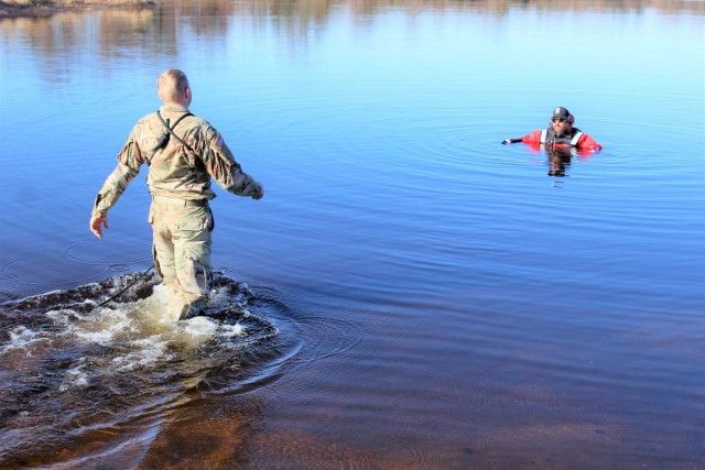 A student in Fort McCoy Cold-Weather Operations Course (CWOC) class 21-05 participates in cold-water immersion training March 19, 2021, at Big Sandy Lake on South Post at Fort McCoy, Wis. CWOC students are trained on a variety of cold-weather...
