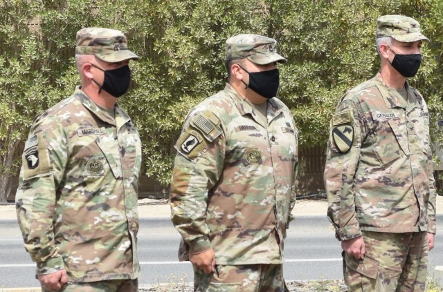 In a military tradition, the Command Sergeant Major, SGM Nathan Marshall, the Senior NCOIC, SFC Joseph Harrison, and Commanding Officer, USACE Transatlantic Afghanistan District, Col. Mark Geraldi prepare to UN-case the command colors in Kuwait....