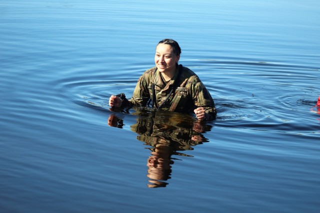 A student in Fort McCoy Cold-Weather Operations Course (CWOC) class 21-05 participates in cold-water immersion training March 19, 2021, at Big Sandy Lake on South Post at Fort McCoy, Wis. CWOC students are trained on a variety of cold-weather...