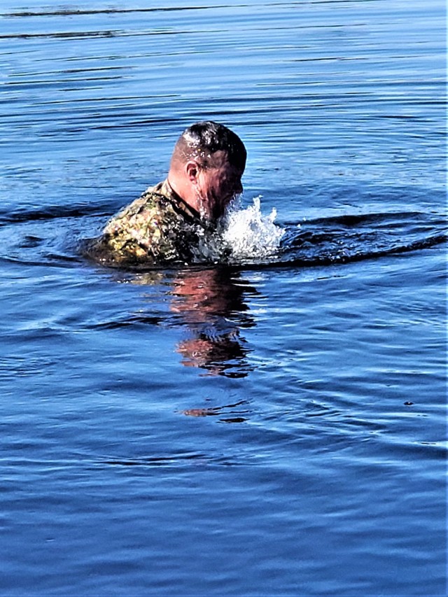 A student in Fort McCoy Cold-Weather Operations Course (CWOC) class 21-05 participates in cold-water immersion training March 19, 2021, at Big Sandy Lake on South Post at Fort McCoy, Wis. CWOC students are trained on a variety of cold-weather...