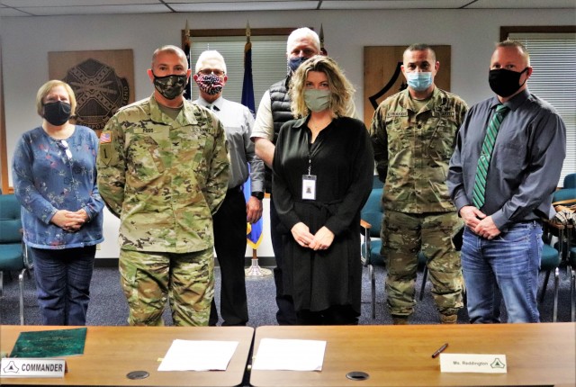 (From left) Fort McCoy Resource Management Officer Maureen Richardson, Garrison Commander Col. Michael Poss, Deputy to the Garrison Commander Brad Stewart, Vernon County Highway Commissioner Phil Hewitt, Vernon County Administrator Cari Reddington, Fort McCoy Staff Judge Advocate Lt. Col. Savas Kyriakidis, and Directorate of Public Works Operations and Maintenance Division Chief Nathan Sobojinski were all on hand for the signing of an intergovernmental service agreement (IGSA) between the post and Vernon County on March 15, 2021, at Fort McCoy, Wis. The agreement involves line striping on roadways at Fort McCoy and is estimated to save the installation more than $166,000 over the next 10 years. It is the second IGSA the post has made in the last two years. (U.S. Army Photo by Scott T. Sturkol, Public Affairs Office, Fort McCoy, Wis.)