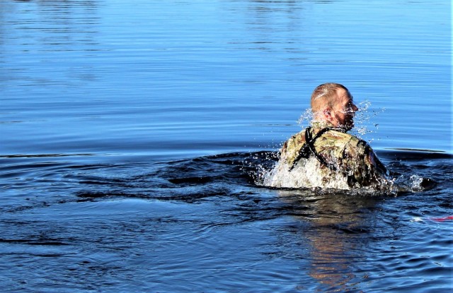 A student in Fort McCoy Cold-Weather Operations Course (CWOC) class 21-05 participates in cold-water immersion training March 19, 2021, at Big Sandy Lake on South Post at Fort McCoy, Wis. CWOC students are trained on a variety of cold-weather...