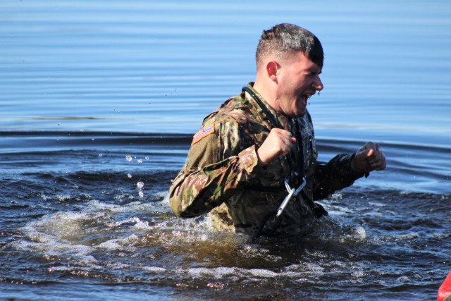 A student in Fort McCoy Cold-Weather Operations Course (CWOC) class 21-05 participates in cold-water immersion training March 19, 2021, at Big Sandy Lake on South Post at Fort McCoy, Wis. CWOC students are trained on a variety of cold-weather...