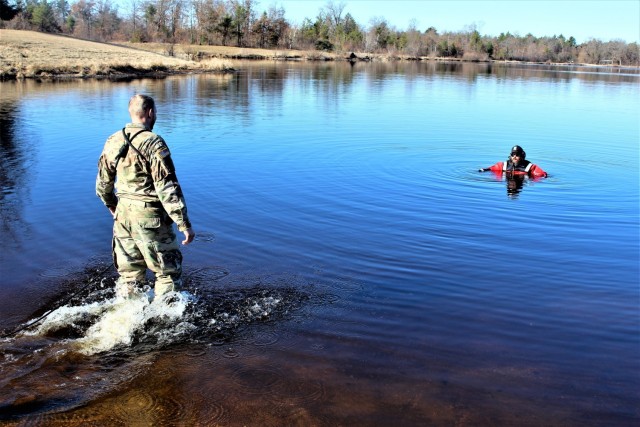 A student in Fort McCoy Cold-Weather Operations Course (CWOC) class 21-05 participates in cold-water immersion training March 19, 2021, at Big Sandy Lake on South Post at Fort McCoy, Wis. CWOC students are trained on a variety of cold-weather...