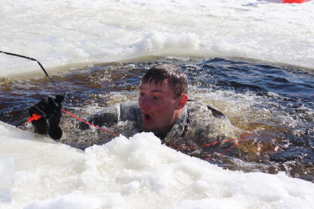 A service member participates in cold-water immersion training Feb. 28, 2020, at a training area on South Post at Fort McCoy, Wis. Training like this contributed to Fort McCoy’s $1.479 billion local economic impact during fiscal year 2020. Thousands of people train at the installation every year which also translates to money spent in local economies. (U.S. Army Photo by Scott T. Sturkol, Public Affairs Office, Fort McCoy, Wis.)