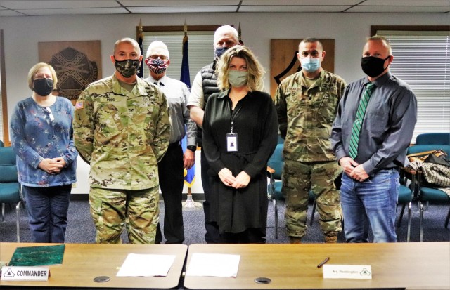 (From left) Fort McCoy Resource Management Officer Maureen Richardson, Garrison Commander Col. Michael Poss, Deputy to the Garrison Commander Brad Stewart, Vernon County Highway Commissioner Phil Hewitt, Vernon County Administrator Cari Reddington, Fort McCoy Staff Judge Advocate Lt. Col. Savas Kyriakidis, and Directorate of Public Works Operations and Maintenance Division Chief Nathan Sobojinski were all on hand for the signeing of an intergovernmental service agreement (IGSA) between the post and Vernon County on March 15, 2021, at Fort McCoy, Wis. The agreement involves line striping on roadways at Fort McCoy and is estimated to save the installation more than $166,000 over the next 10 years. It is the second IGSA the post has made in the last two years. (U.S. Army Photo by Scott T. Sturkol, Public Affairs Office, Fort McCoy, Wis.)