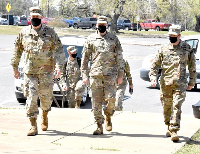 Maj. Gen. Timothy P. McGuire, (left) IMCOM deputy commander, Col. Ryan K. Roseberry, (middle) Fort Polk garrison commander, and Command Sgt. Maj. Christopher Ausbun, garrison command sergeant major, prepare to check out barracks renovations on...