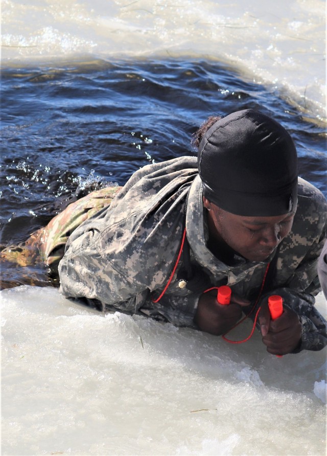 Airman 1st Class Alexis Edwards with the 164th Security Forces Squadron at Memphis Air National Guard Base, Tenn., participates in cold-water immersion training Feb. 26, 2021, at Big Sandy Lake on South Post at Fort McCoy, Wis. CWOC students are...