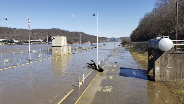 Even after flood waters have receded, large debris, such as tree branches, remain behind for the crew to clean up at the Locks and Dams 3 on the Monongahela River in Elizabeth, Pennsylvania, March 2, 2021. High water from snow melts and extended rain affected the U.S. Army Corps of Engineers Pittsburgh District on the Monongahela River in early March. Elizabeth Locks and Dams (L/D 3) was taken out of service as water entered the operating machinery and topped the lock walls. The average time of high-water stopping operation was 30 hours. The lock staff cleared mud and debris, and each lock was returned to service within eight hours of water receding. Elizabeth is one of the oldest functioning locks in the nation, 114 years old. (U.S. Army Corps of Engineers Pittsburgh District Photo by Philip Delo)
