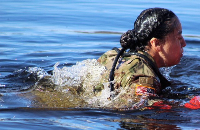 A student in Fort McCoy Cold-Weather Operations Course (CWOC) class 21-05 participates in cold-water immersion training March 19, 2021, at Big Sandy Lake on South Post at Fort McCoy, Wis. CWOC students are trained on a variety of cold-weather...