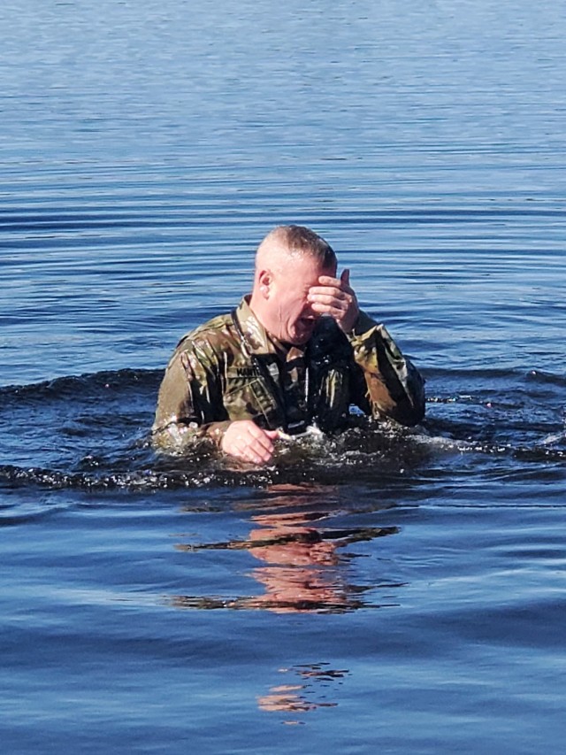 A student in Fort McCoy Cold-Weather Operations Course (CWOC) class 21-05 participates in cold-water immersion training March 19, 2021, at Big Sandy Lake on South Post at Fort McCoy, Wis. CWOC students are trained on a variety of cold-weather...