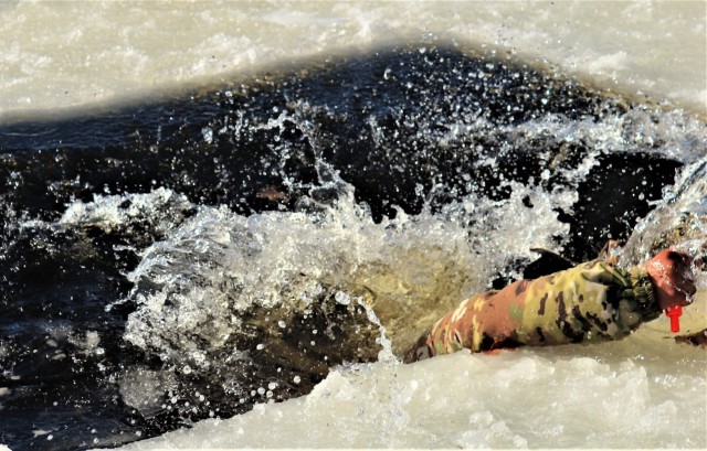 Airman 1st Class Jarva Brown with the 164th Security Forces Squadron at Memphis Air National Guard Base, Tenn., participates in cold-water immersion training Feb. 26, 2021, at Big Sandy Lake on South Post at Fort McCoy, Wis. CWOC students are...