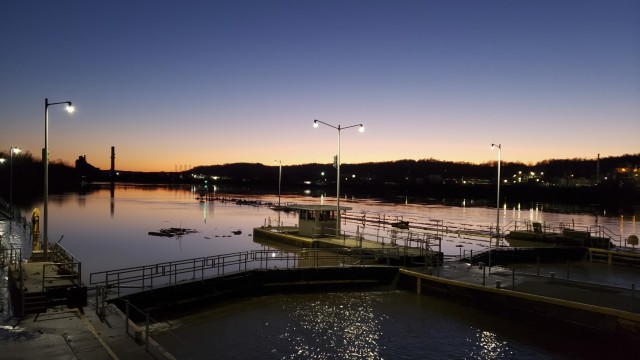 The waters recede after a flood incident at the Locks and Dams 3 on the Monongahela River in Elizabeth, Pennsylvania, during sunset, March 2, 2021. High water from snow melts and extended rain affected the U.S. Army Corps of Engineers Pittsburgh District on the Monongahela River in early March. Elizabeth Locks and Dams (L/D 3) was taken out of service as water entered the operating machinery and topped the lock walls. The average time of high-water stopping operation was 30 hours. The lock staff cleared mud and debris, and each lock was returned to service within eight hours of water receding. Elizabeth is one of the oldest functioning locks in the nation, 114 years old. (U.S. Army Corps of Engineers Pittsburgh District Photo by Philip Delo)