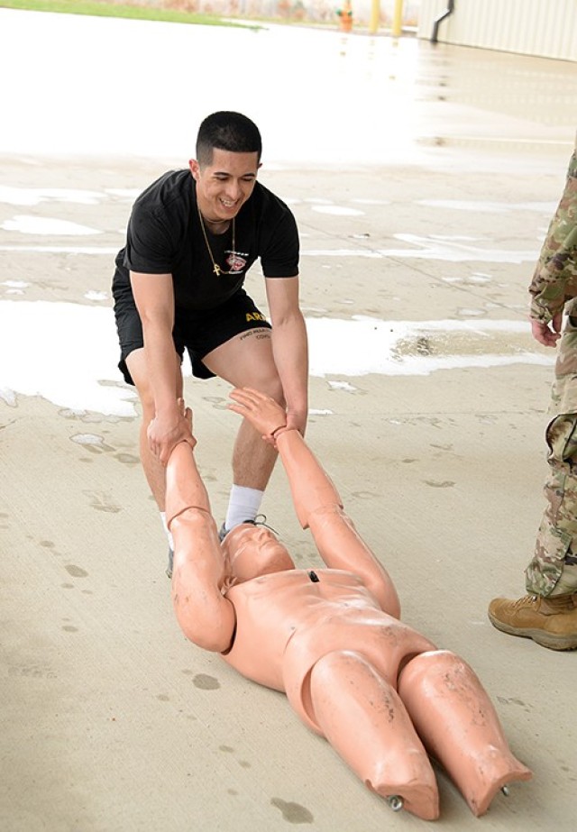 Sgt. Alberto Alfaro, 165th Military Police Company, 705th MP Battalion (Detention), drags a dummy 100 meters in the Iron Griffin gauntlet course, which also included 100-meter iterations of a water jug carry, bear crawl and sprint, during the 15th MP Brigade NCO and Soldier of the Year competition March 25 outside the company operations facilities. Alfaro was named NCO of the Year for the 705th MP Battalion and will go on to represent Fort Leavenworth in the Combined Arms Center competition. Photo by Prudence Siebert/Fort Leavenworth Lamp