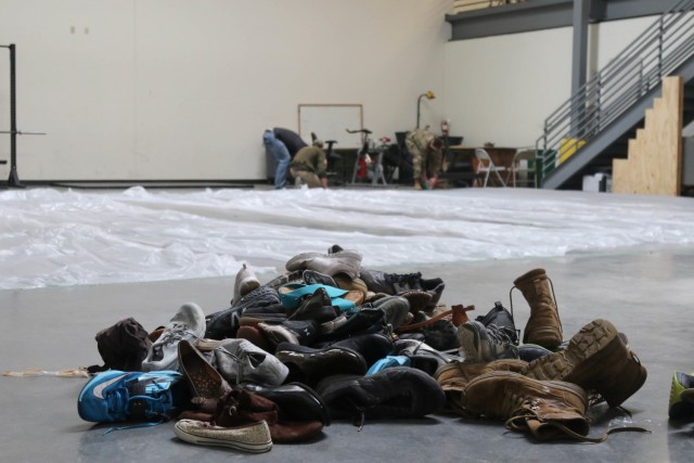 A pile of shoes sits on the floor waiting to be painted teal by Soldiers, Airmen and Space Force Guardians March 19 at Fort Carson in preparation for a Sexual Assault Awareness Prevention Month display. (Photo by Capt. Jason Elmore)